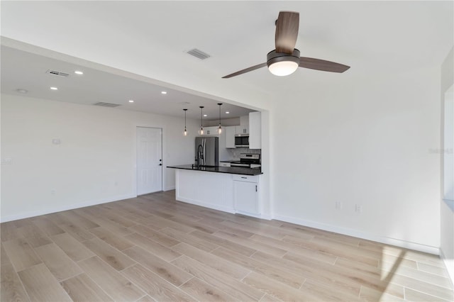 unfurnished living room with ceiling fan and light hardwood / wood-style floors