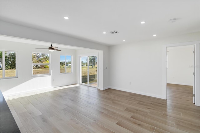 empty room with ceiling fan and light wood-type flooring