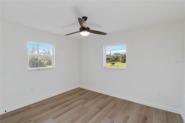 spare room featuring ceiling fan and light wood-type flooring