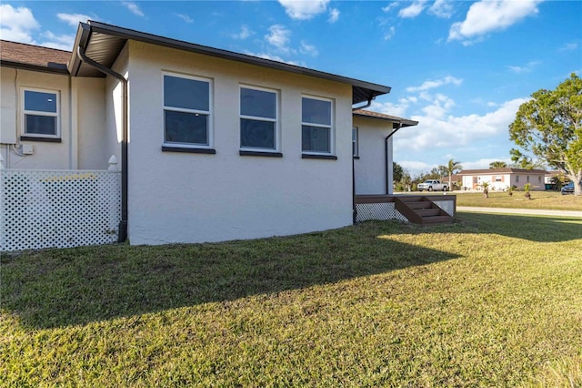 view of side of home featuring a yard