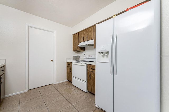 kitchen featuring light tile patterned floors and white appliances