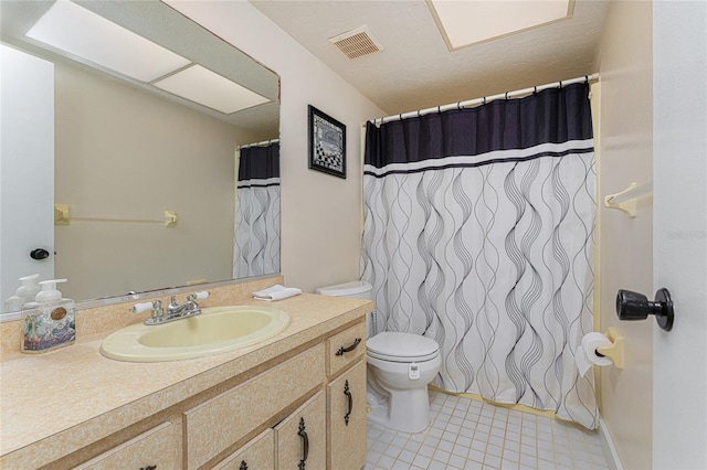 bathroom featuring vanity, walk in shower, and toilet