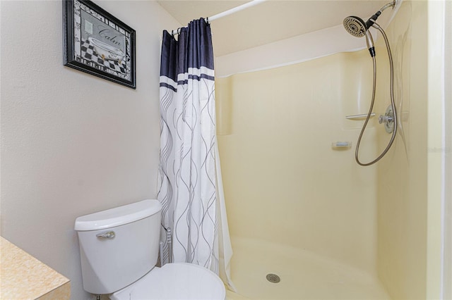 bathroom featuring curtained shower and toilet