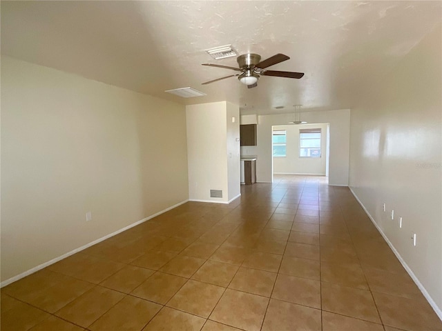 unfurnished living room featuring ceiling fan and light tile patterned flooring