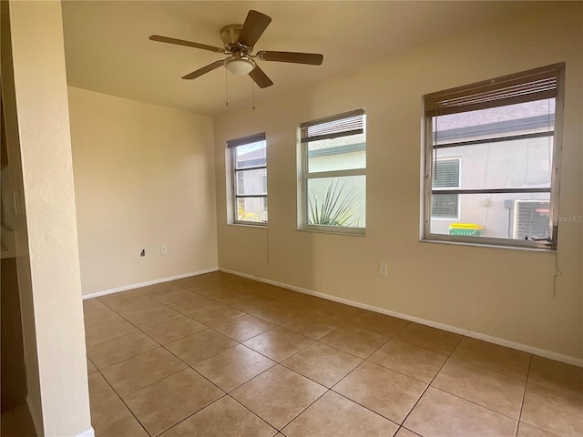 tiled spare room with ceiling fan