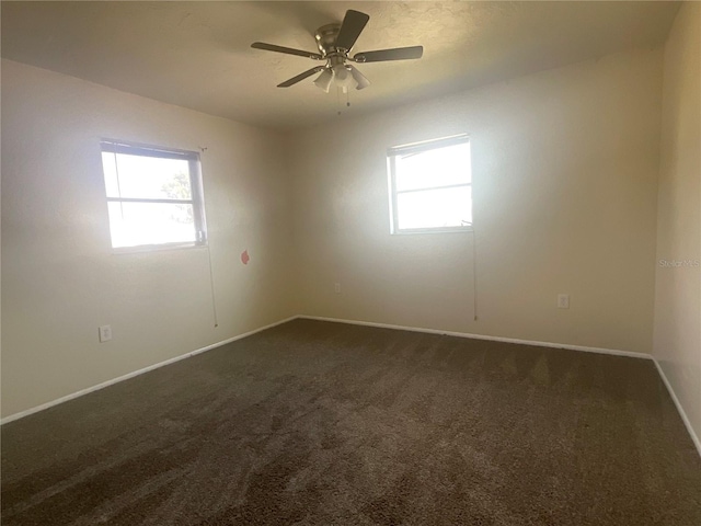 carpeted empty room featuring plenty of natural light and ceiling fan