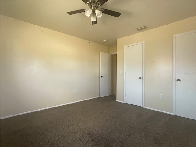 unfurnished bedroom featuring dark carpet and ceiling fan