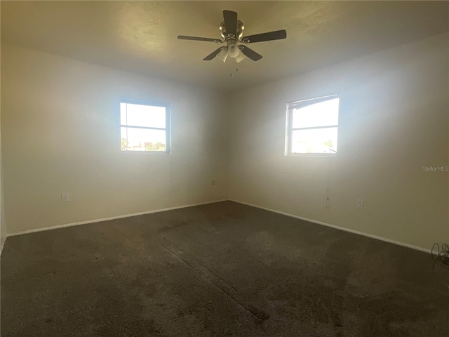 carpeted empty room featuring ceiling fan