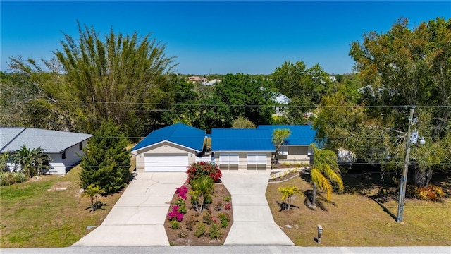 view of front of property with roof mounted solar panels and a front lawn