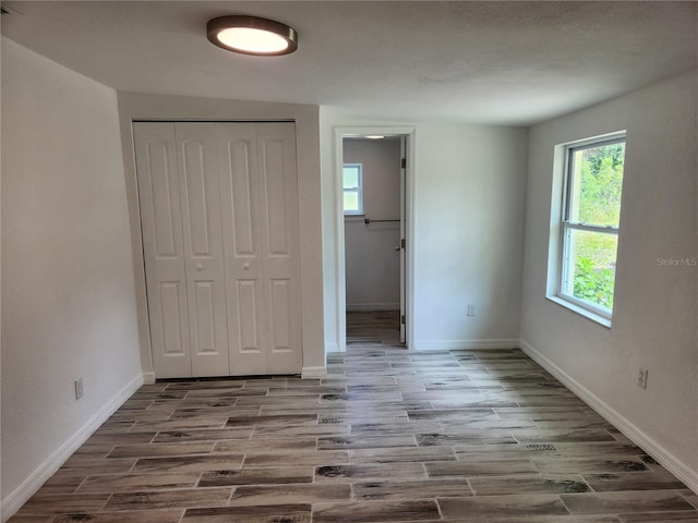 unfurnished bedroom with hardwood / wood-style floors and a closet