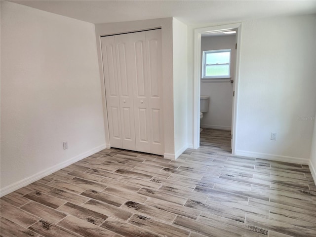 unfurnished bedroom with light hardwood / wood-style floors and a closet