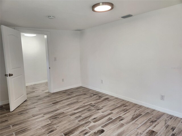 unfurnished room with light wood-type flooring