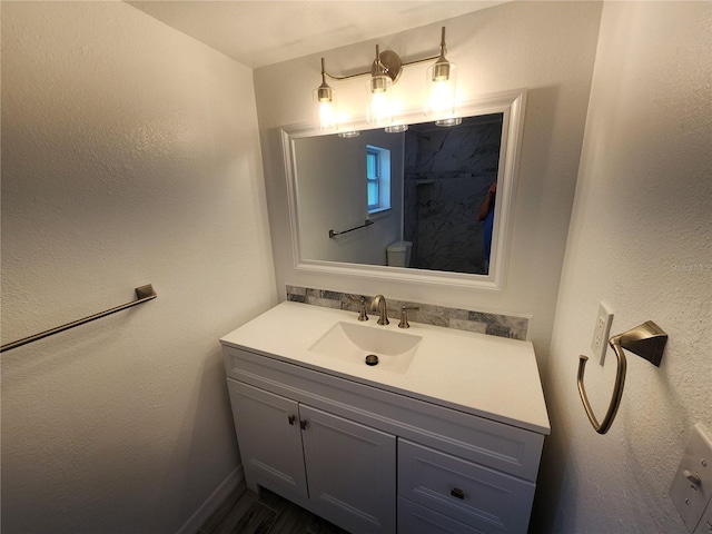 bathroom featuring vanity and toilet