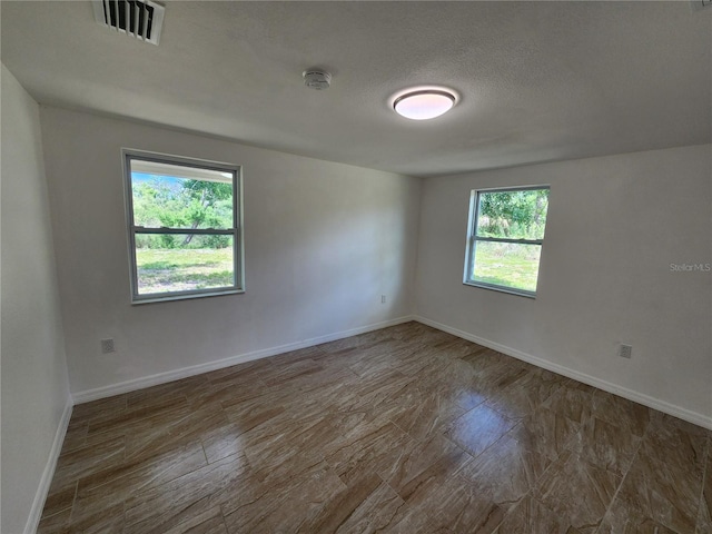 spare room with a textured ceiling