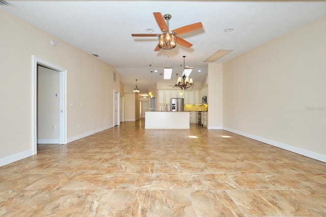 unfurnished living room with ceiling fan with notable chandelier