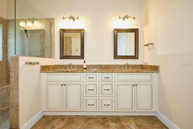 bathroom with vanity and tiled shower