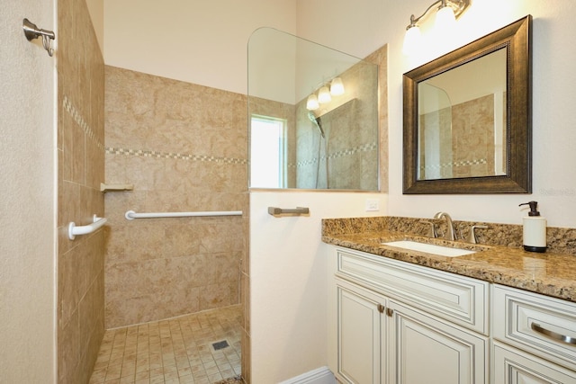 bathroom with vanity and tiled shower