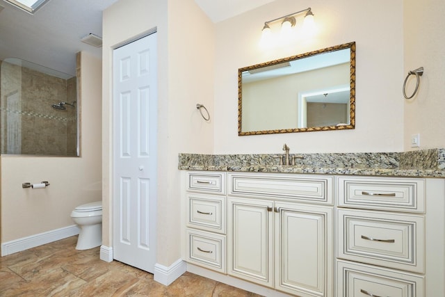 bathroom featuring vanity, toilet, and tiled shower