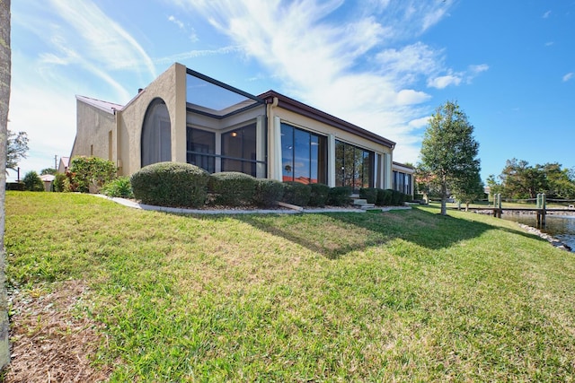 view of home's exterior with a lawn