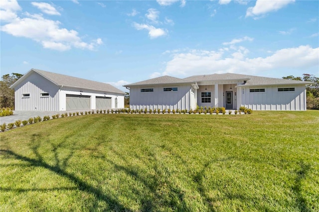 view of front of property featuring a garage and a front lawn