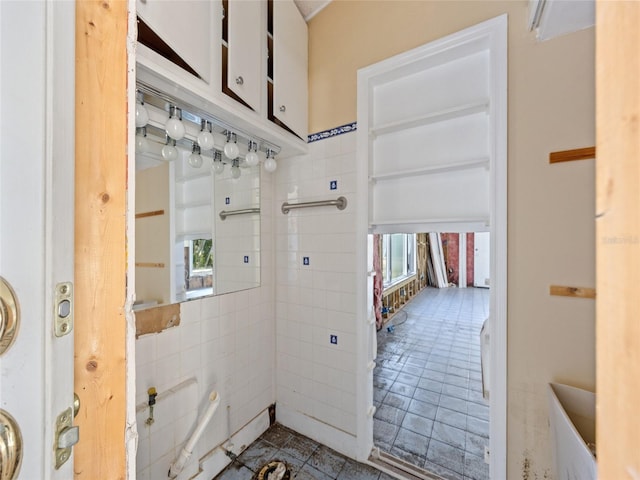 interior space featuring plenty of natural light and tile walls