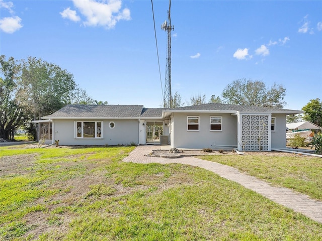 ranch-style home with a patio, central AC unit, and a front lawn