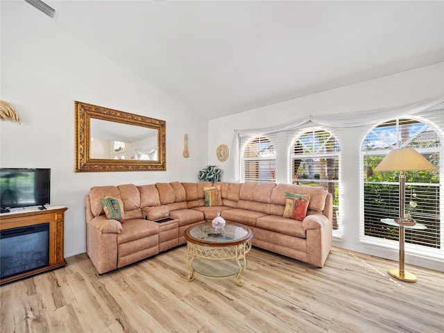 living room featuring vaulted ceiling and light wood-type flooring