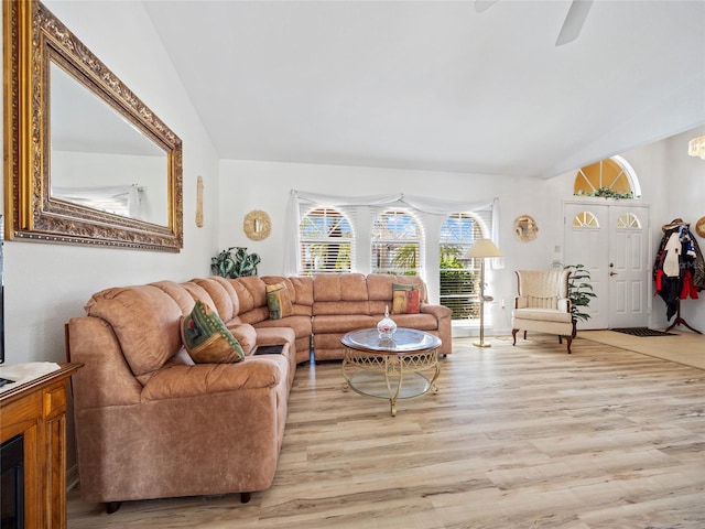 living room featuring lofted ceiling, ceiling fan, and light wood-type flooring