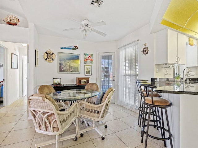 tiled dining space featuring sink and ceiling fan