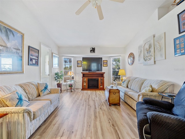 living room featuring ceiling fan, light hardwood / wood-style floors, and a healthy amount of sunlight