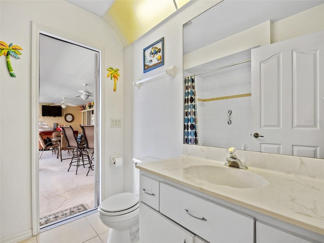 bathroom with ceiling fan, tile patterned flooring, vanity, a shower with curtain, and toilet