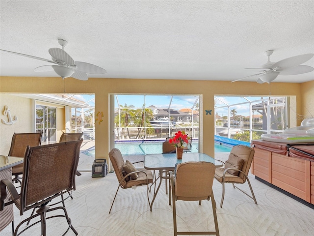 sunroom featuring plenty of natural light and ceiling fan