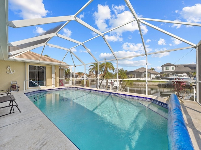 view of swimming pool with a water view, a lanai, and a patio