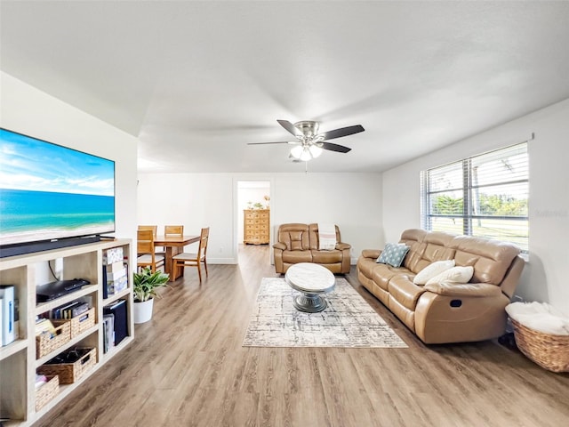 living room with ceiling fan and light hardwood / wood-style flooring