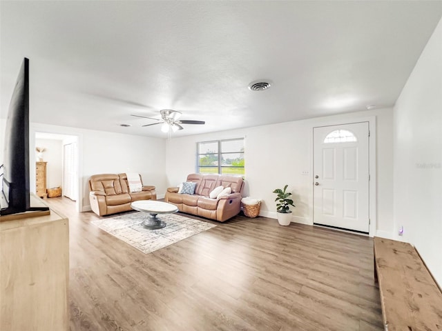 living room featuring light hardwood / wood-style floors and ceiling fan