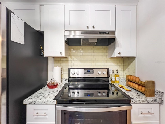 kitchen with white cabinetry, light stone counters, stainless steel appliances, and decorative backsplash