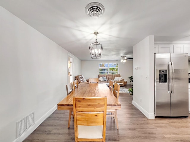 dining room with a chandelier and light hardwood / wood-style floors