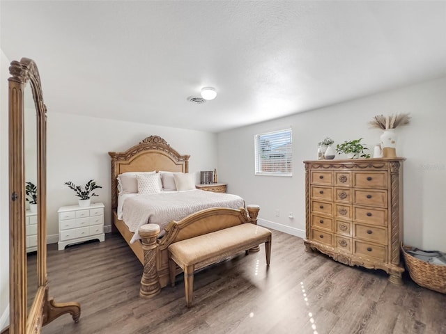 bedroom with dark hardwood / wood-style flooring