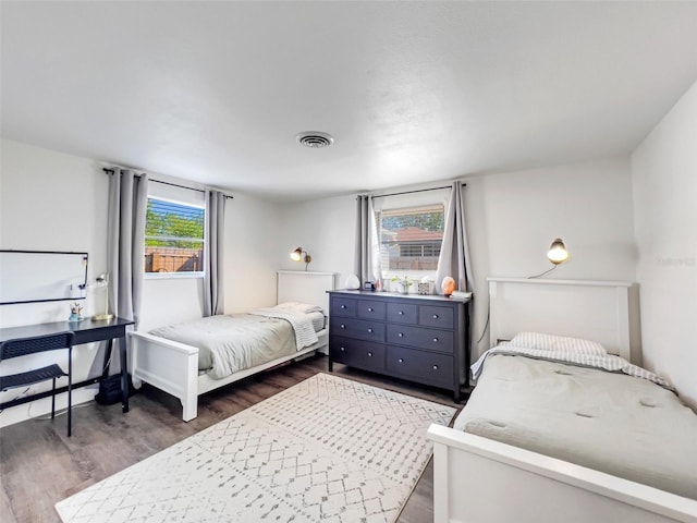 bedroom with dark hardwood / wood-style flooring