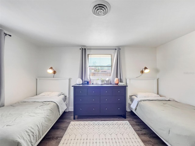 bedroom with dark wood-type flooring