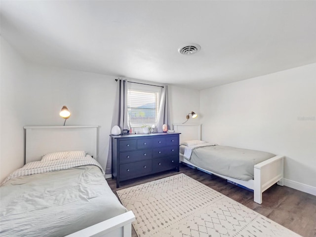 bedroom with dark hardwood / wood-style floors