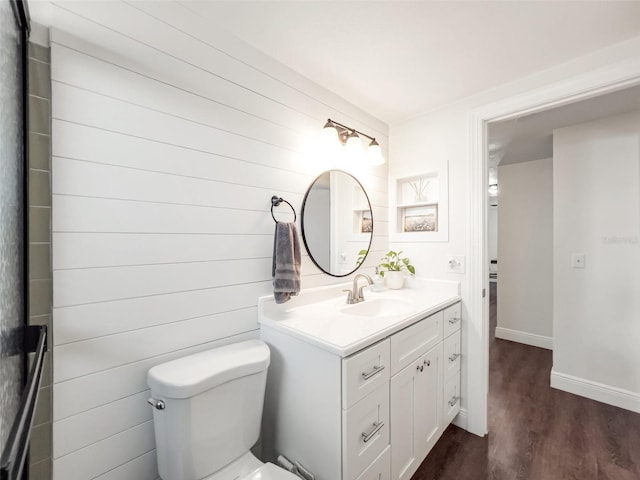 bathroom featuring vanity, hardwood / wood-style flooring, and toilet