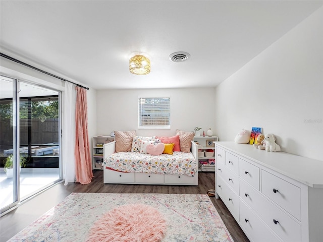 bedroom featuring access to exterior and dark wood-type flooring