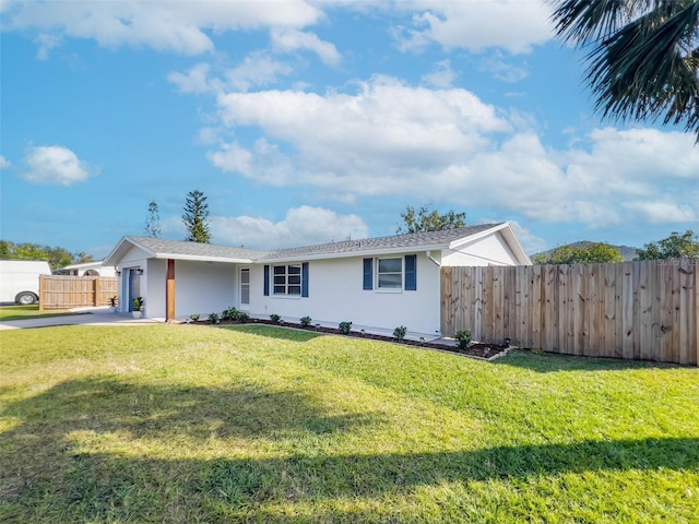 ranch-style home with a garage and a front yard