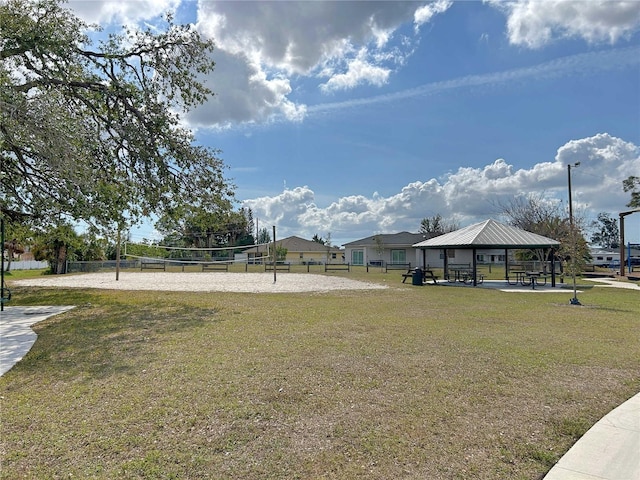 surrounding community with a gazebo, a lawn, and volleyball court