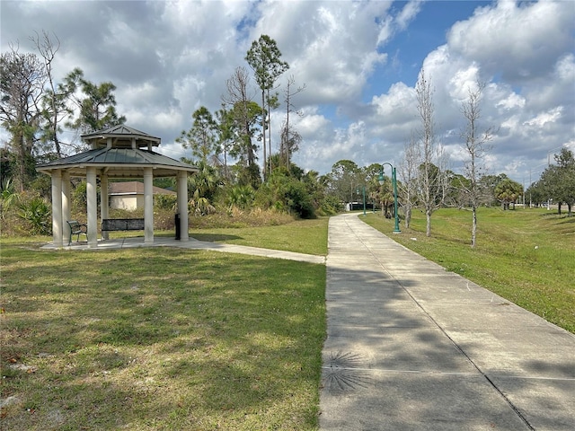 view of community with a playground, a gazebo, and a lawn