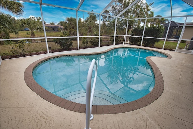 view of pool featuring a patio and glass enclosure