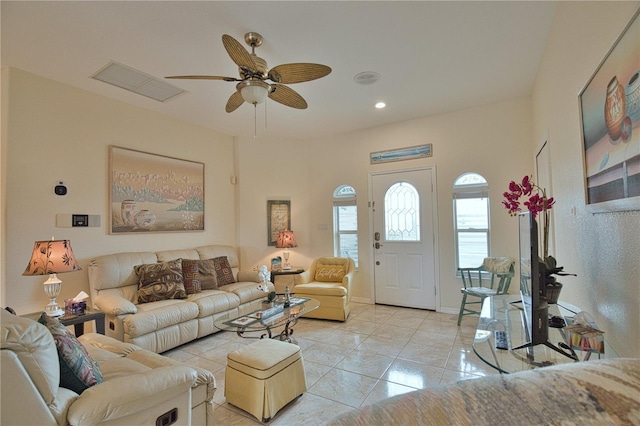 tiled living room featuring ceiling fan