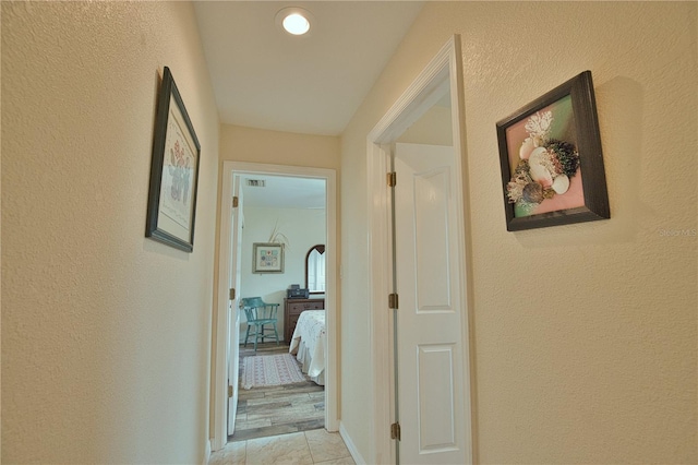 hallway featuring light tile patterned floors