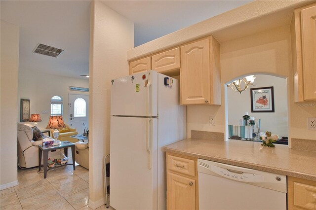 kitchen featuring light tile patterned flooring, white appliances, and light brown cabinetry